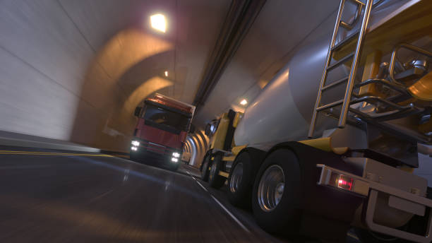 low angle view of a cement mixer and a semi truck on the move inside an illuminated tunnel - truck motion road cement truck imagens e fotografias de stock