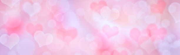 istock Romantic pink and lilac bokeh background with hearts. Pastel valentine backdrop. 1297808756