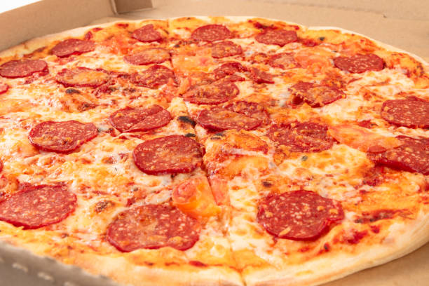 istock fresh aromatic Italian pepperoni pizza with mozzarella cheese in a cardboard box 1297810884