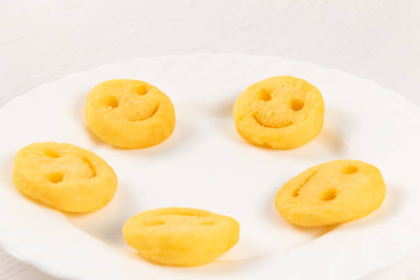 fresh potato emoticons fries on white plate close-up on white wooden table background fresh potato hot emoticons fries on white plate close-up on white wooden table background smiling potato stock pictures, royalty-free photos & images