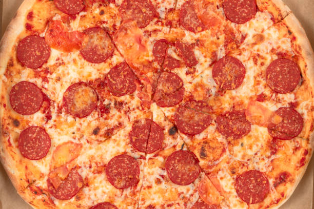 istock fresh aromatic Italian pepperoni pizza with mozzarella cheese in a cardboard box 1297810961