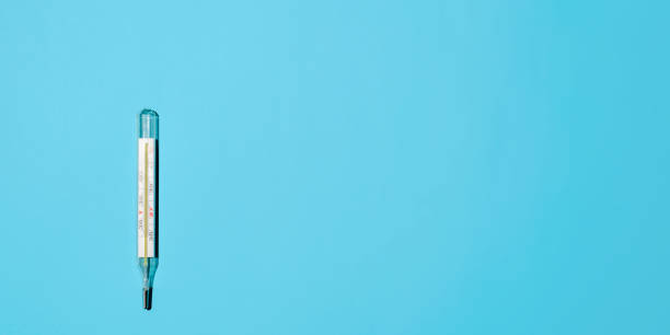istock Classic Celsius thermometer on a light blue background, flat lay. Banner, space for text on the right. Medical minimalist photo 1297813350