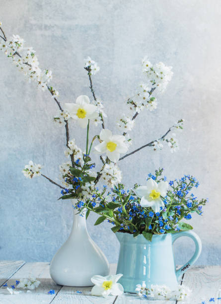 istock spring  flowers in  vases  on background old  wall 1297813925