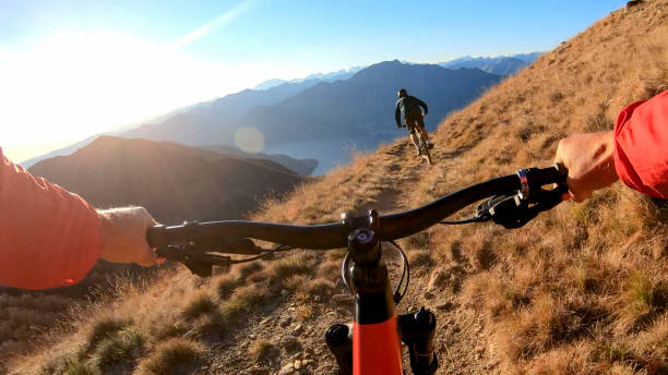 istock Mountain bikers ride along mountain ridge in the morning 1297817411