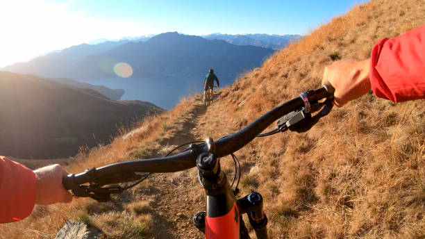 istock Mountain bikers ride along mountain ridge in the morning 1297817429