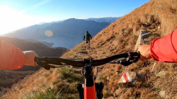 istock Mountain bikers ride along mountain ridge in the morning 1297817435