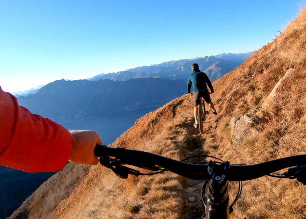 istock Mountain bikers ride along mountain ridge in the morning 1297817458