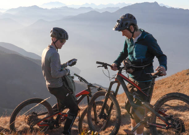 istock Mountain bikers relax on mountain ridge in the morning 1297817489