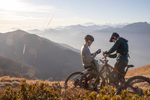 istock Mountain bikers relax on mountain ridge in the morning 1297817490