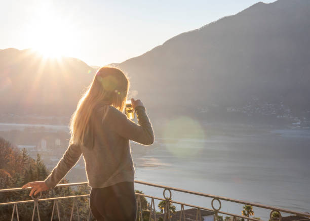 istock Young woman relaxes on balcony at sunrise 1297817613