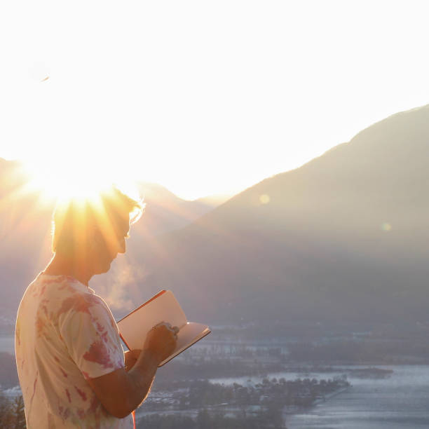 istock Man relaxes on balcony overlooking Lake Maggiore at sunrise 1297817848