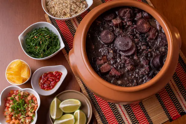 Traditional Brazilian food called Feijoada. Black beans with pork.