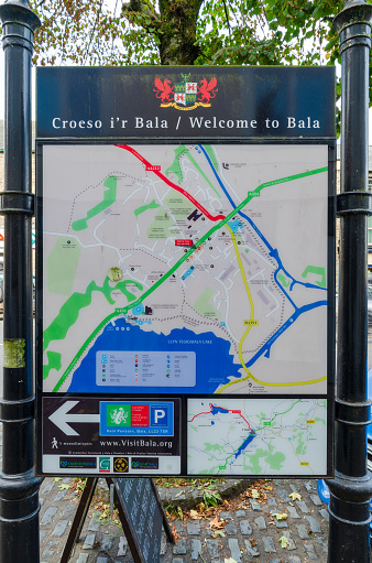 Bala; UK: Sep 20, 2020: A map of the town is displayed on a public notice board on the High Street. The map shows useful places for visitors and tourists.