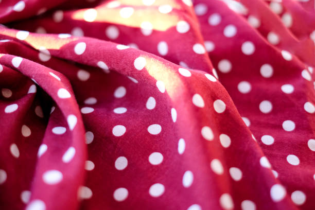 istock Wine red color faric with polka dots, abstract colorful background, sunlight effect 1297820643