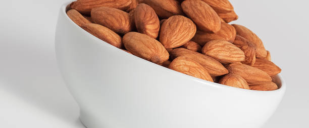 Almond in white cup on white background.