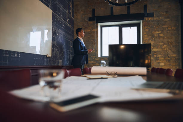 istock Merry engineer with a cellphone in his office 1297822006