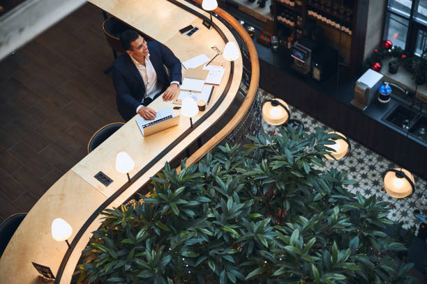 istock Joyful entrepreneur seated at the table looking away 1297822052