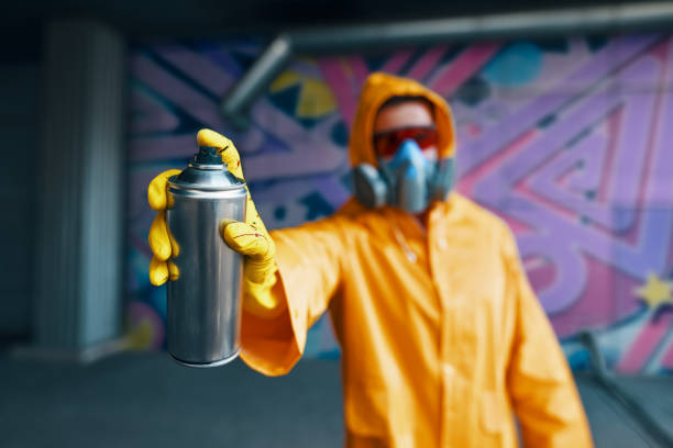 istock Graffiti artist pointing spray paint can to camera 1297823618