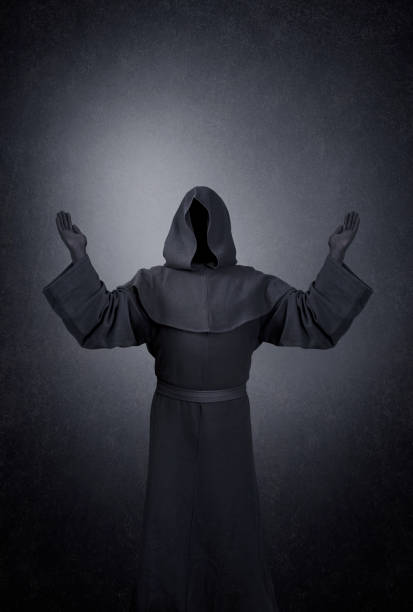 istock Ghostly figure with hands up in the dark 1297824406