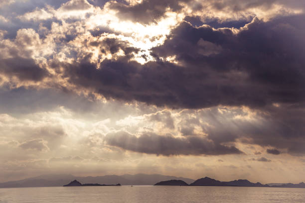 istock Dramatic clouds sky at sunset over pacific ocean, Komodo, Indonesia 1297824427