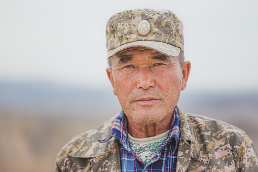 Portrait of an elderly Kazakh man park ranger in Charyn Canyon National Park, Kazakhstan.