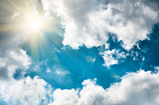 istock clouds in the blue sky and sun, natural background 1297825120