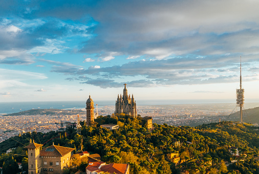Aerial view of Barcelona skyline with Tibidabo Sagrat Cor temple during sunset, Catalonia, Spain