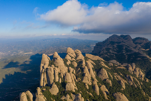 Aerial view of the Montserrat conglomerate crags, a huge vertical fingers multi peaks taken by drone in a unique place on earth in the Catalonia region