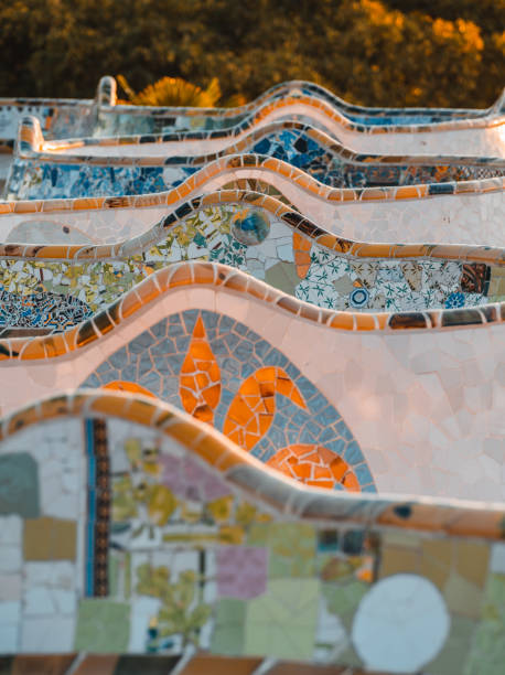 Beautiful sunrise in Barcelona seen from Park Guell. Park was built from 1900 to 1914 and was officially opened as a public park in 1926. In 1984, UNESCO declared the park a World Heritage Site