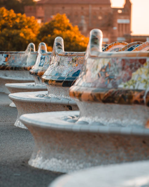 Beautiful sunrise in Barcelona seen from Park Guell. Park was built from 1900 to 1914 and was officially opened as a public park in 1926. In 1984, UNESCO declared the park a World Heritage Site