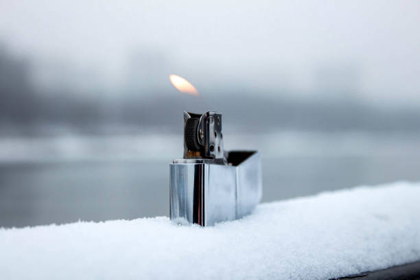 istock Flaming lighter zippo. Lighter on snow in the winter 1297829820