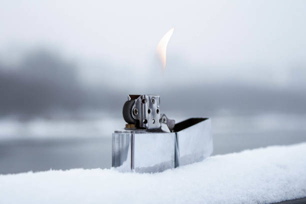 Flaming lighter zippo. Lighter on snow in the winter