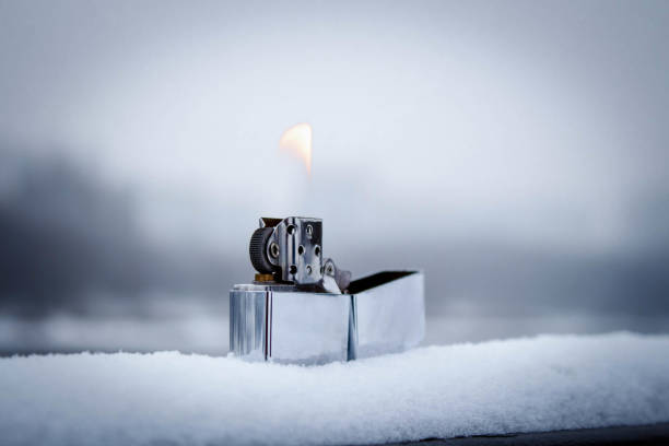 istock Flaming lighter zippo. Lighter on snow in the winter 1297829825