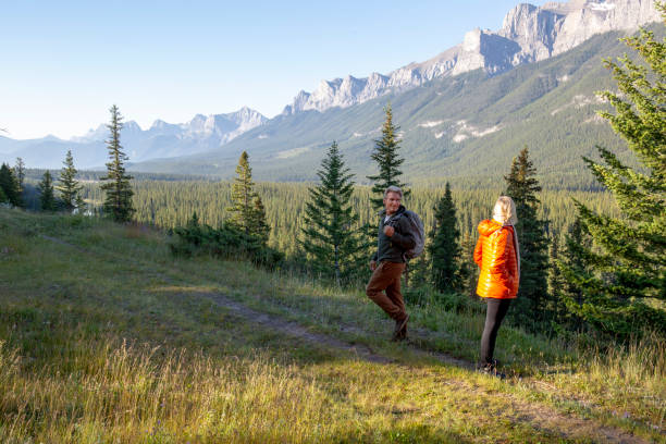 istock Couple hike in different directions on valley trail 1297829954