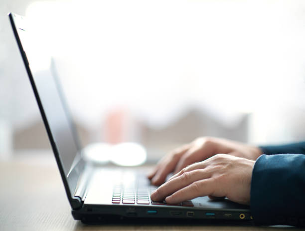 istock Man's hands typing on a laptop keyboard 1297831609