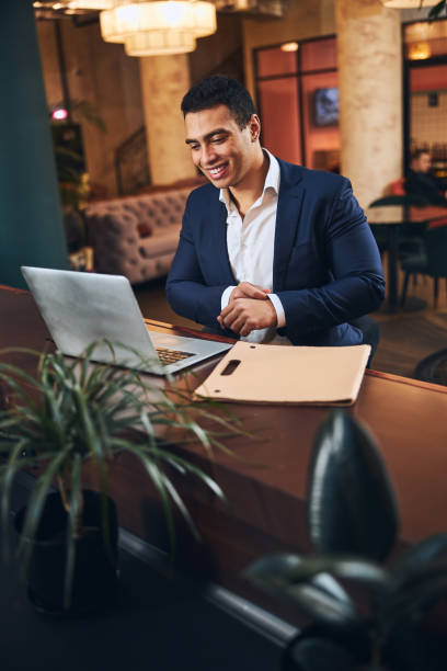 istock Contented young businessman enjoying his virtual communication 1297831696