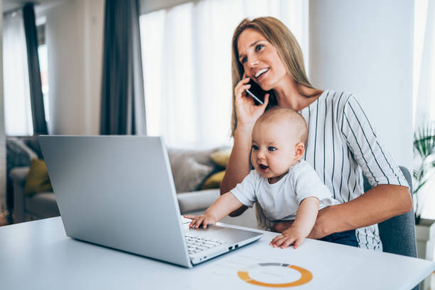istock Mother and baby working at home. 1297832680