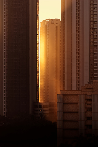 Tall skyscrapers in downtown suburban Mumbai with evening sun rays during golden hour.