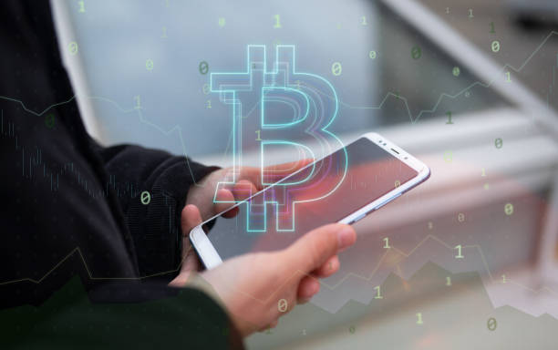 istock Unrecognizable person using his smart phone and trading Bitcoin. Bitcoin / Cryptocurrency concept. 1297835788