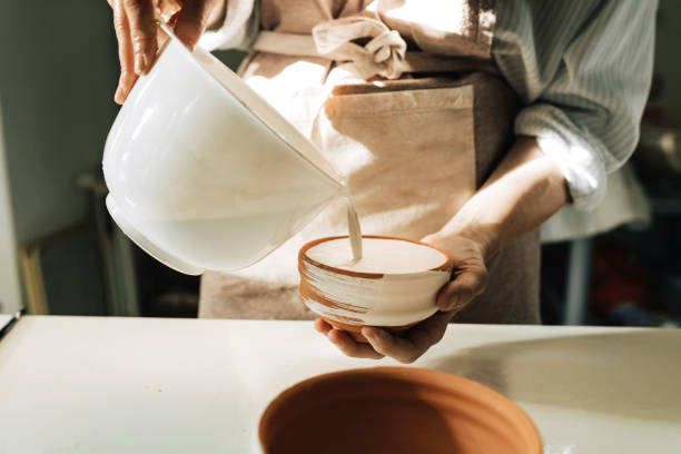 istock Woman Artisan Colouring Ceramic Bowl 1297835931