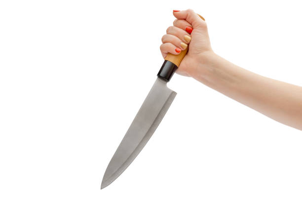 istock Woman's hand holding knife. Isolated on white. 1297840324