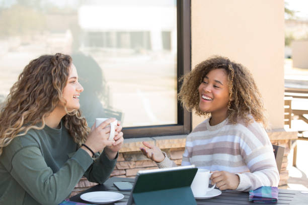 istock Two great friends enjoying an afternoon break at a sidewalk cafe. 1297841587