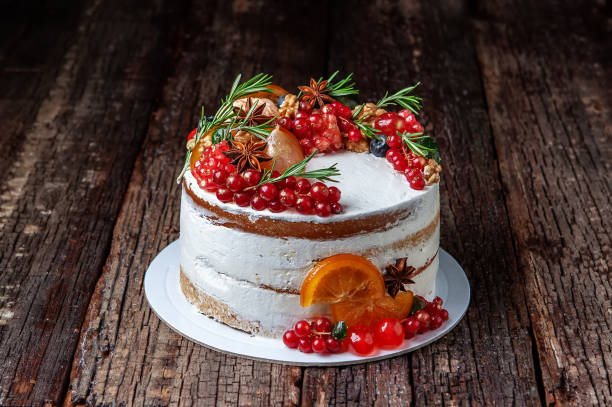 istock Tasty sweet cake decorated with fruit and rosemary, placed on old rustic table. 1297843669