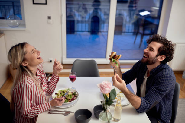 istock A young couple having a good time while eating together. Home, kitchen, meal, relationship 1297845034