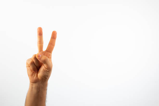istock hand making the peace sign on a white background with high key effect 1297845078