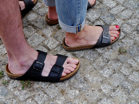 Couple barefoot on cobblestones