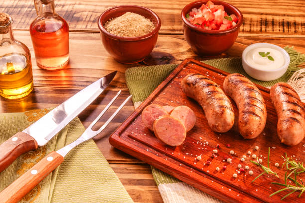 Brazilian sausage Brazilian pork sausage with BBQ fork and knife - Churrasco de linguiça de suina brazilian bbq stock pictures, royalty-free photos & images