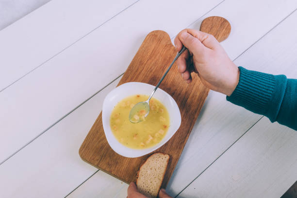 istock The man is eating broth soup from a bowl. 1297847495