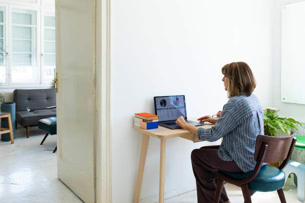 istock At the Home Office: Smiling Businesswoman Working at Home 1297850268