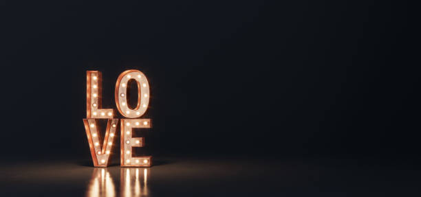 istock Glowing letters love on black background 1297858621